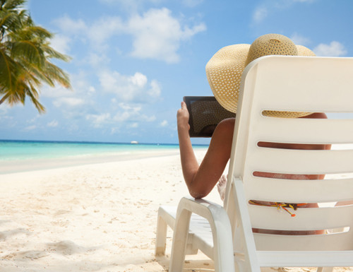 Woman with tablet computer on the beach