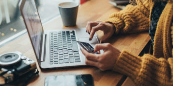 image of Woman in cafe shopping online with laptop